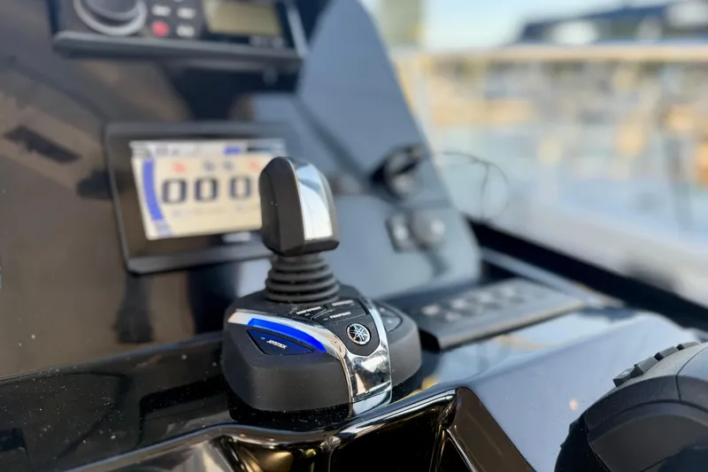 Slide: The Image of Close-up of 2024 Jeanneau NC 1095 boat controls with joystick and display panel. - 37