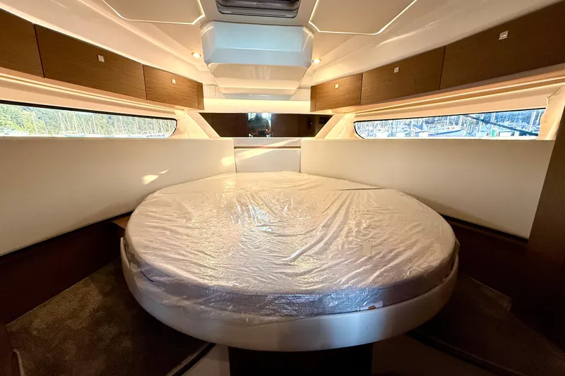 Slide: The Image of Luxurious cabin interior of 2024 Jeanneau NC 1095 with round bed and modern design. - 40