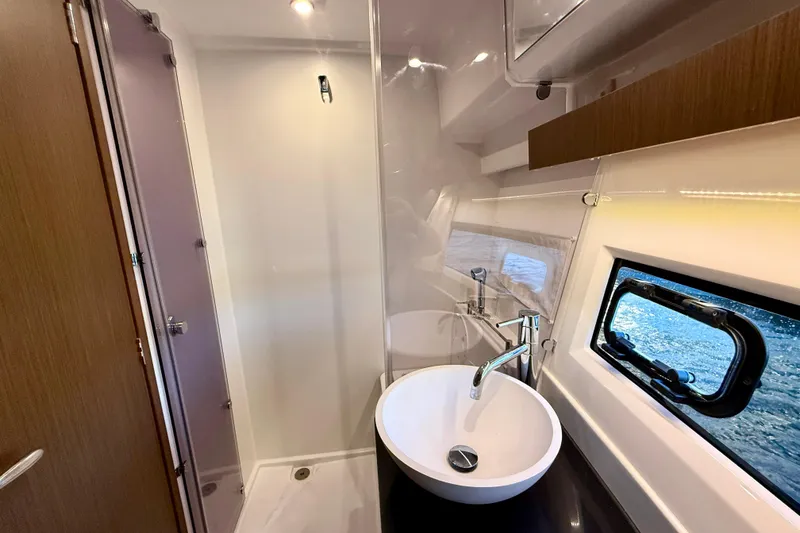 Slide: The Image of 2024 Jeanneau NC 1095 bathroom with modern sink, shower, and window view. - 44