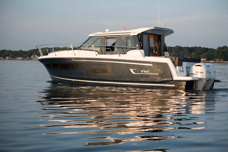 Slide: The Image of 2024 Jeanneau NC 1095 boat cruising on calm water, showcasing sleek design and modern features. - 50