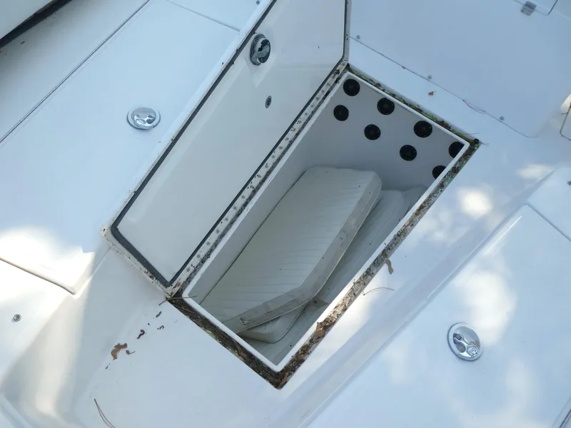 Slide: The Image of Open storage compartment on 2004 Regulator 26 Forward Seating boat with cushions inside. - 10