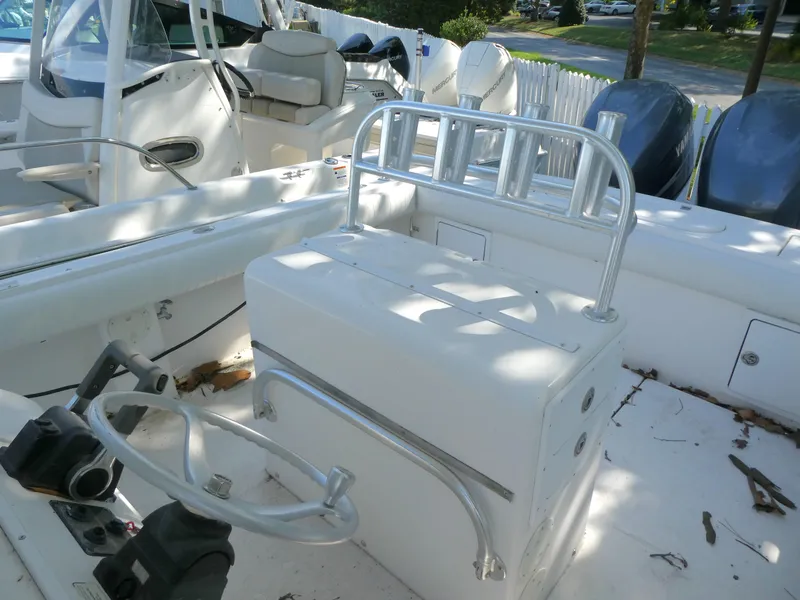 Slide: The Image of 2004 Regulator 26 Forward Seating boat interior with helm and seating area. - 7
