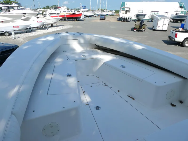 Slide: The Image of 2004 Regulator 26 Forward Seating boat in a marina, surrounded by other vessels. - 9