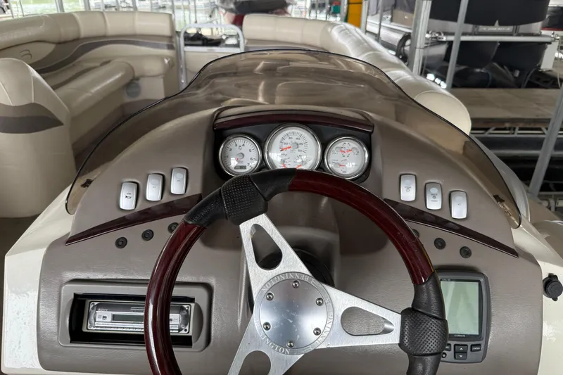 Slide: The Image of 2006 Bennington 2575RL I/O boat dashboard with steering wheel and gauges. - 11