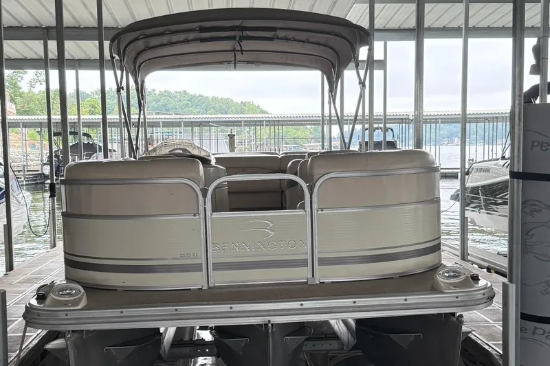 Slide: The Image of 2006 Bennington 2575RL I/O pontoon boat docked in a covered marina. - 13