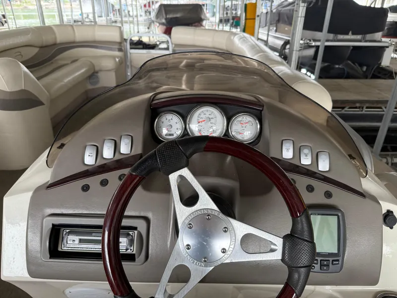 Slide: The Image of 2006 Bennington 2575RL I/O boat dashboard with steering wheel and gauges. - 3