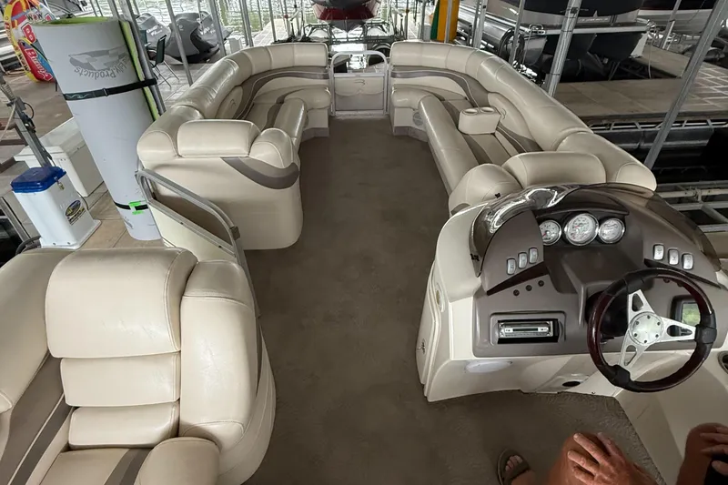 Slide: The Image of Interior of a 2006 Bennington 2575RL I/O boat with beige seating and dashboard. - 4