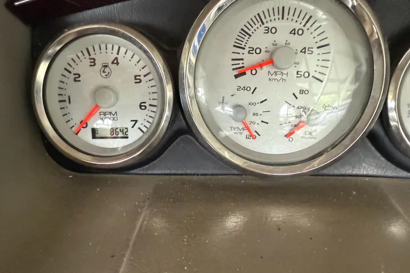 Slide: The Image of Close-up of 2006 Bennington 2575RL I/O boat gauges displaying RPM, speed, temperature, and oil pressure. - 7