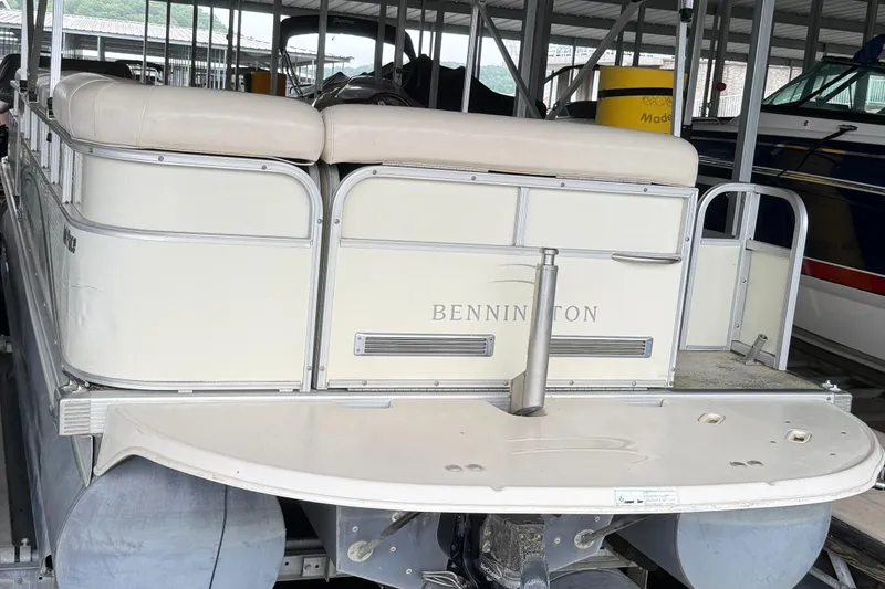 Slide: The Image of 2006 Bennington 2575RL I/O pontoon boat docked in a covered marina. - 9