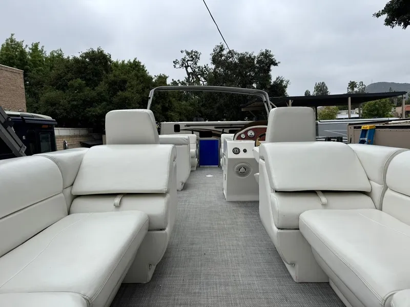 Slide: The Image of 2023 Frontier 24' Cruiser boat with spacious white seating and modern design. - 14