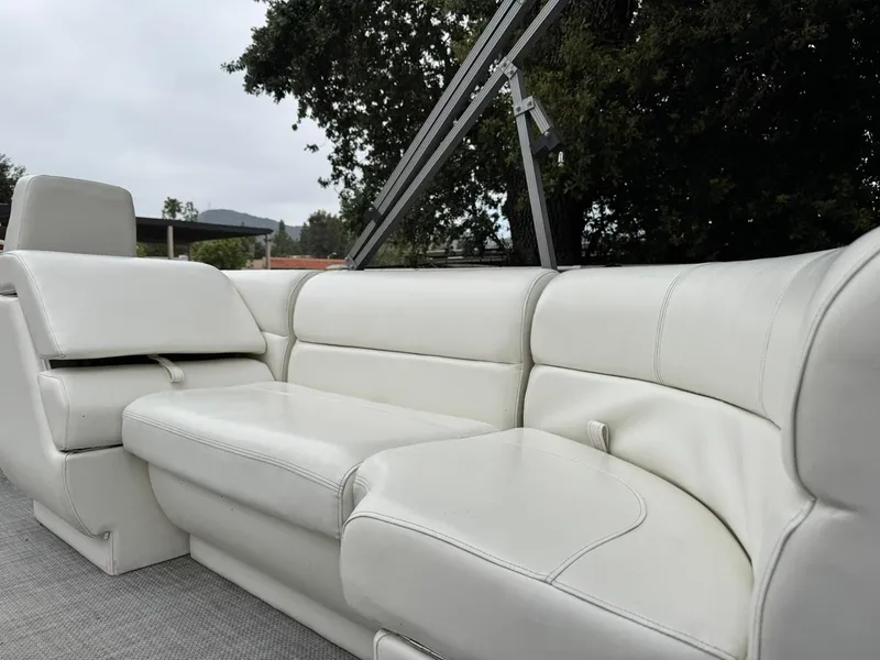 Slide: The Image of 2023 Frontier 24' Cruiser boat with white leather seating and sleek design. - 16