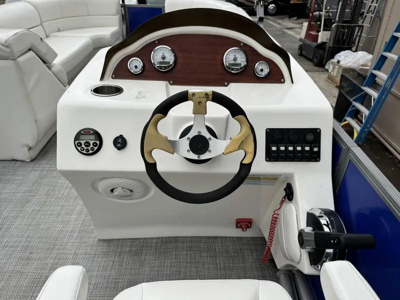 Slide: The Image of 2023 Frontier 24' Cruiser boat dashboard with steering wheel and control panel. - 19
