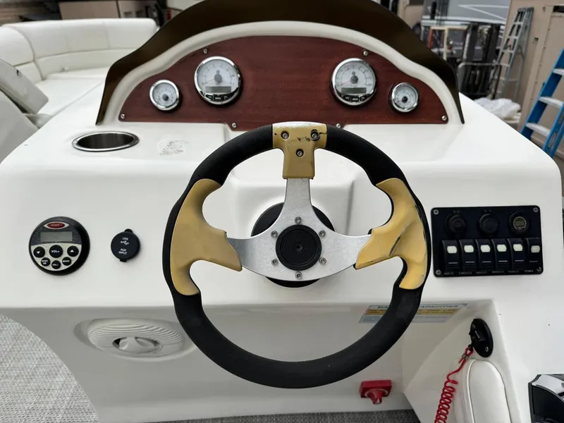 Slide: The Image of Steering console of 2023 Frontier 24' Cruiser with gauges and controls. - 20