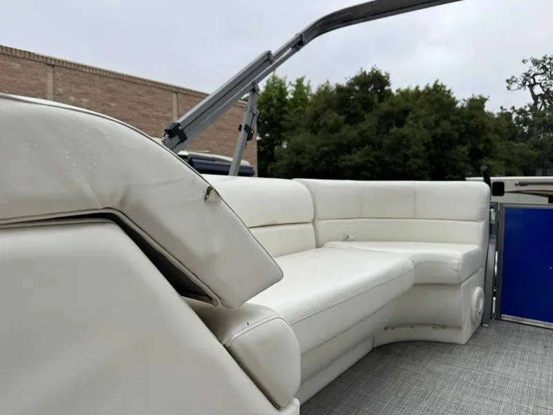 Slide: The Image of 2023 Frontier 24' Cruiser boat interior with white seating and gray flooring. - 25