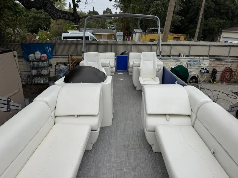 Slide: The Image of 2023 Frontier 24' Cruiser boat with spacious white seating and modern design. - 26