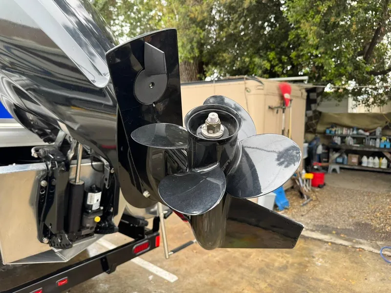 Slide: The Image of Close-up of a 2023 Frontier 24' Cruiser boat propeller in a workshop setting. - 32