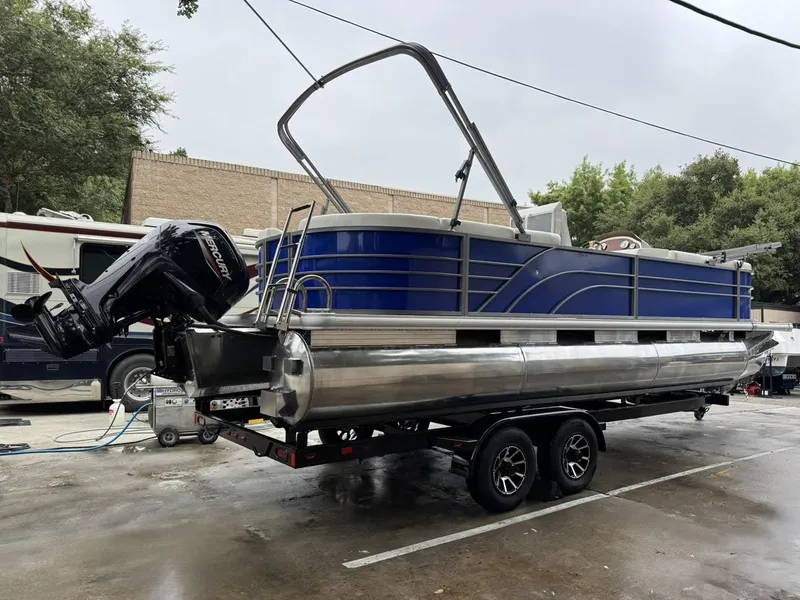 Slide: The Image of 2023 Frontier 24' Cruiser pontoon boat on trailer, featuring a Mercury outboard motor. - 4