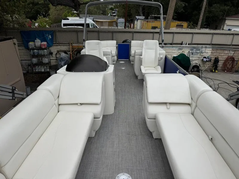 Slide: The Image of 2023 Frontier 24' Cruiser boat with spacious white seating and modern design. - 5