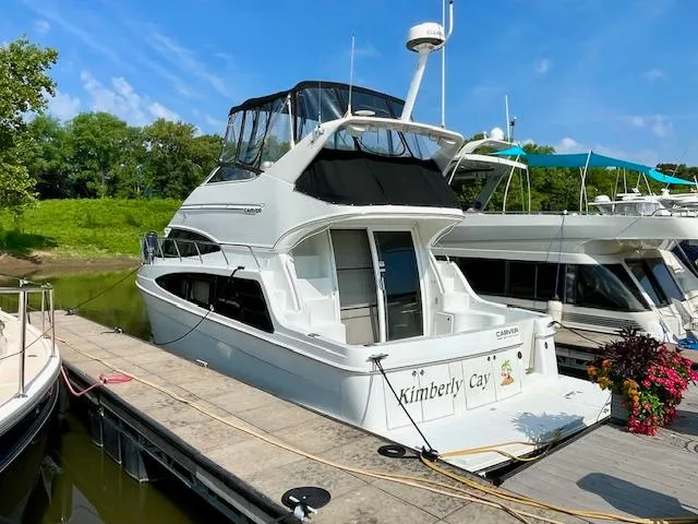 The Image of 2003 Carver 360 Sport Sedan docked, featuring sleek design and spacious upper deck. - 1
