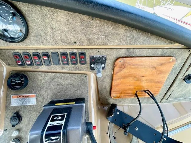 Slide: The Image of Control panel of a 2003 Carver 360 Sport Sedan boat with switches and thruster controls. - 15