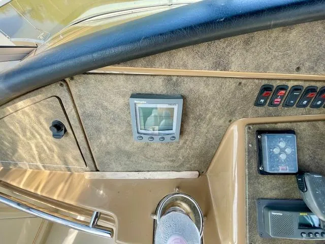 Slide: The Image of Control panel of a 2003 Carver 360 Sport Sedan boat, featuring navigation and control switches. - 16