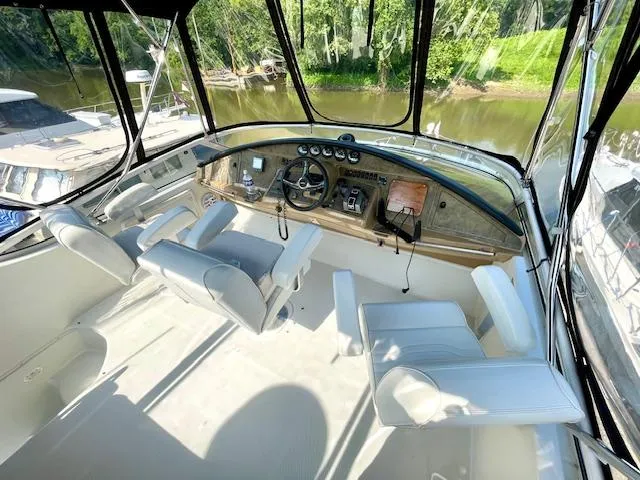 Slide: The Image of 2003 Carver 360 Sport Sedan cockpit with white seating and river view. - 18
