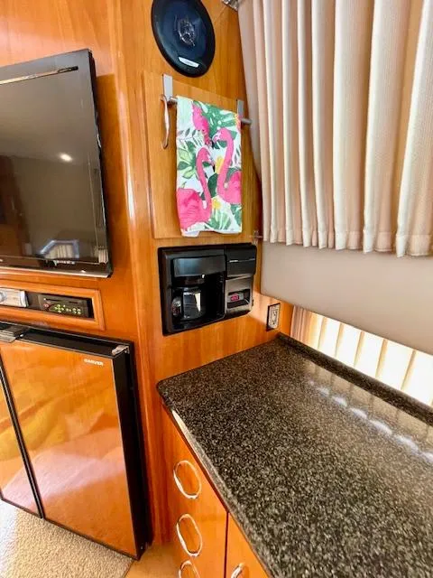 Slide: The Image of Interior of 2003 Carver 360 Sport Sedan with kitchenette, TV, and coffee maker. - 25