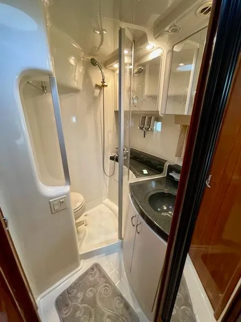 Slide: The Image of 2003 Carver 360 Sport Sedan bathroom with shower, sink, and toilet in compact, modern design. - 35