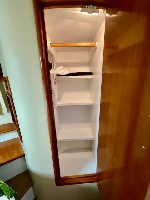 Slide: The Image of Open wooden closet with shelves inside a 2003 Carver 360 Sport Sedan. - 40
