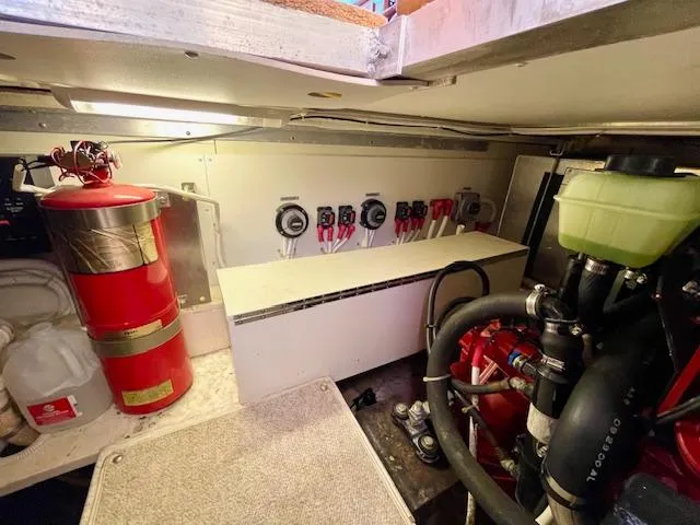 Slide: The Image of Engine room of a 2003 Carver 360 Sport Sedan with fire extinguisher and control panel. - 44