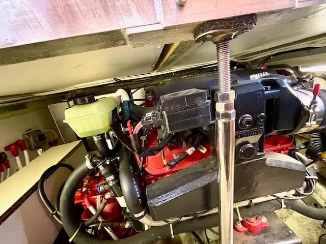 Slide: The Image of Engine compartment of a 2003 Carver 360 Sport Sedan, showcasing mechanical components and wiring. - 46