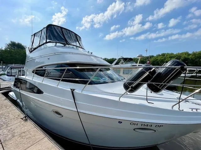 Slide: The Image of 2003 Carver 360 Sport Sedan docked under a clear blue sky. - 6