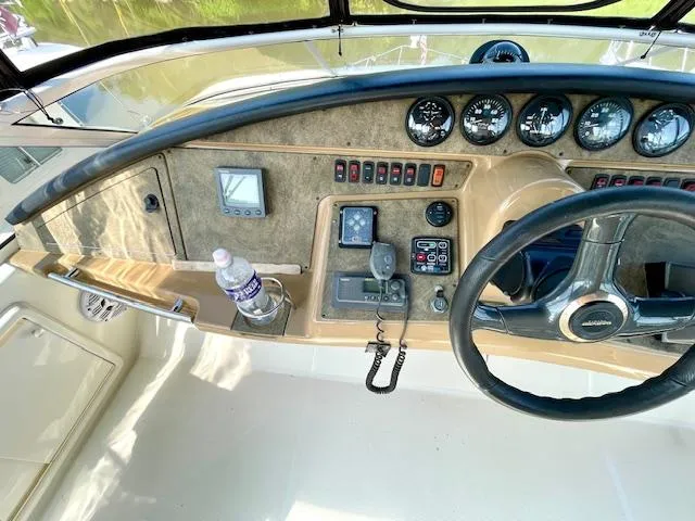 Slide: The Image of 2003 Carver 360 Sport Sedan helm with steering wheel, gauges, and control panel. - 12