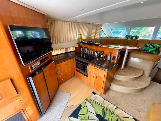 Slide: The Image of Interior of 2003 Carver 360 Sport Sedan with kitchen, TV, and seating area. - 22