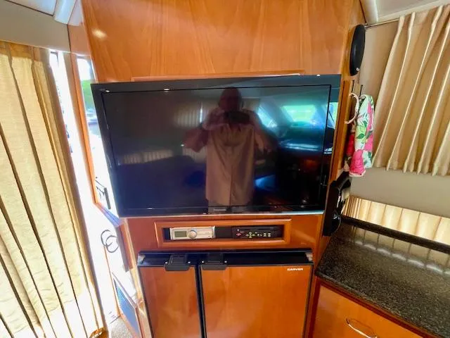 Slide: The Image of Interior of 2003 Carver 360 Sport Sedan with TV and wooden cabinetry. - 24