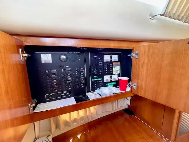 Slide: The Image of Electrical panel inside 2003 Carver 360 Sport Sedan yacht with wooden cabinetry. - 30