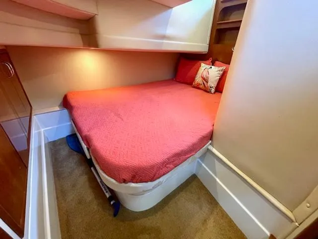 Slide: The Image of 2003 Carver 360 Sport Sedan cabin with red bedding and cozy interior design. - 38