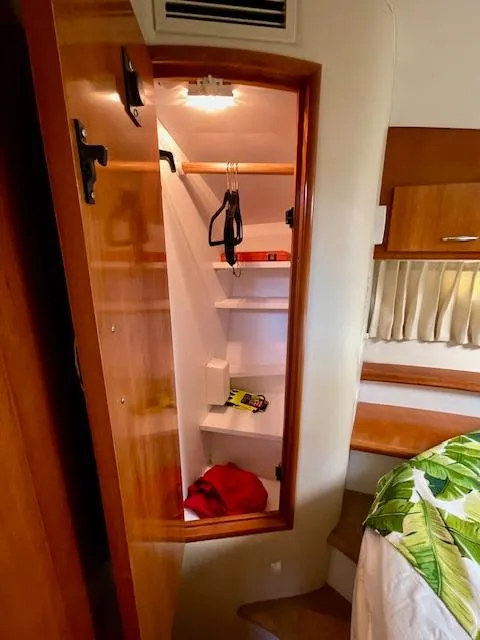 Slide: The Image of 2003 Carver 360 Sport Sedan interior closet with shelves and hangers. - 41