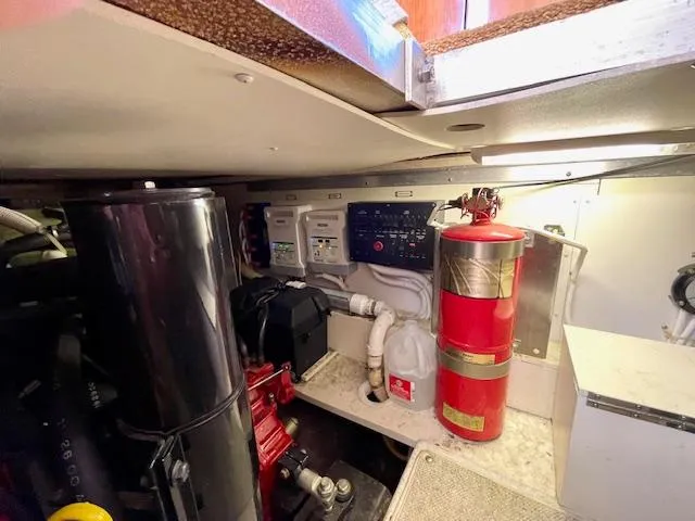 Slide: The Image of Engine room of 2003 Carver 360 Sport Sedan with fire extinguisher and control panel. - 43