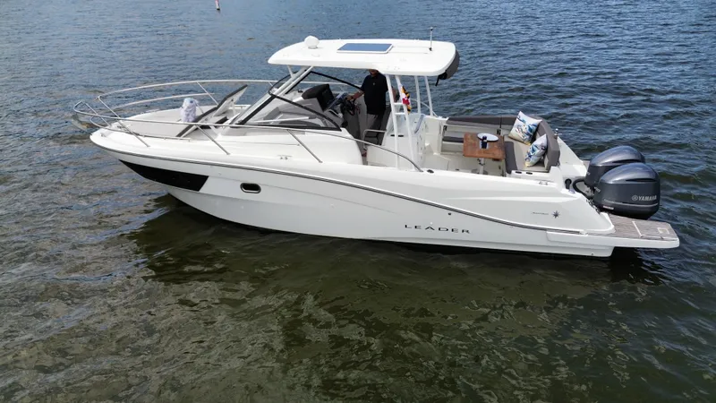 The Image of 2018 Jeanneau Leader 10.5 boat on water, featuring sleek design and dual Yamaha engines. - 1