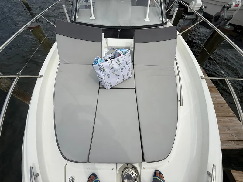 Slide: The Image of 2018 Jeanneau Leader 10.5 boat with cushioned deck and a patterned bag. - 14