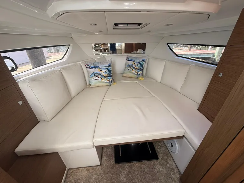 Slide: The Image of Luxurious interior of 2018 Jeanneau Leader 10.5 with plush seating and decorative pillows. - 18