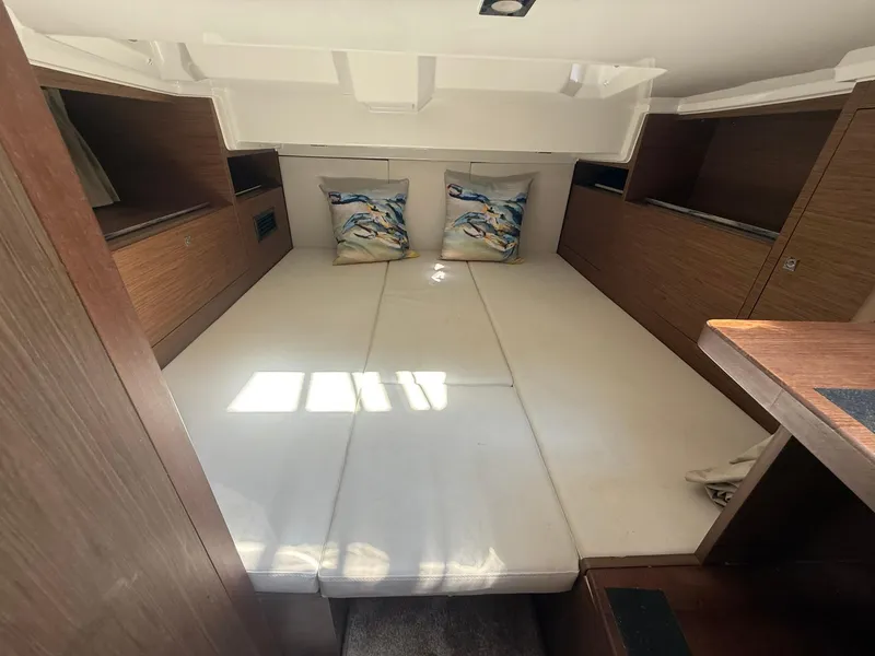 Slide: The Image of 2018 Jeanneau Leader 10.5 cabin interior with cozy bedding and wooden accents. - 23
