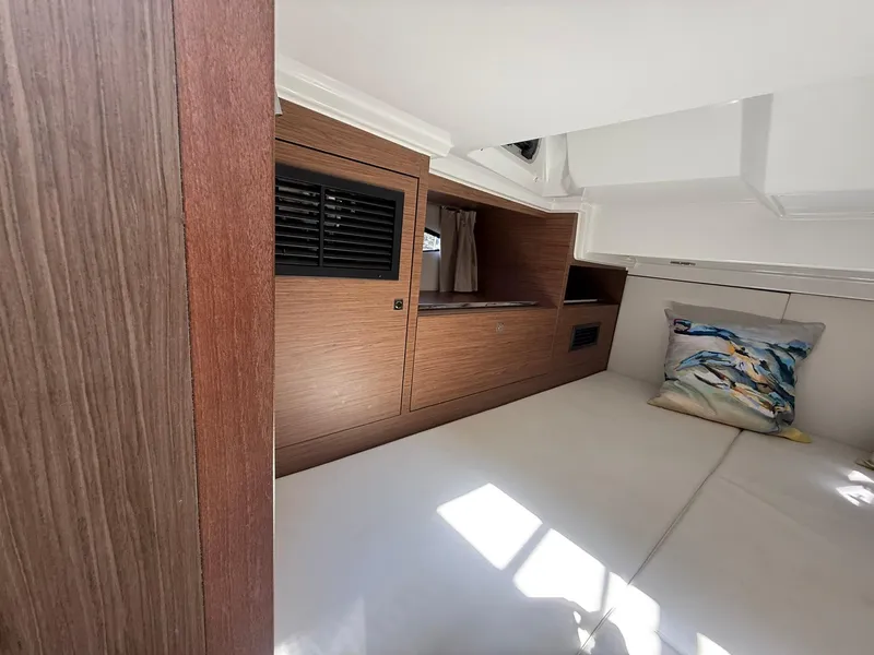 Slide: The Image of Interior cabin of 2018 Jeanneau Leader 10.5 with wood paneling and decorative pillow. - 24