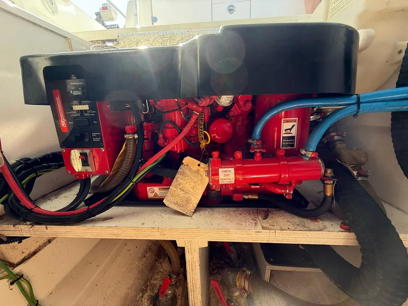 Slide: The Image of Engine compartment of a 2018 Jeanneau Leader 10.5 boat, featuring red mechanical components. - 26