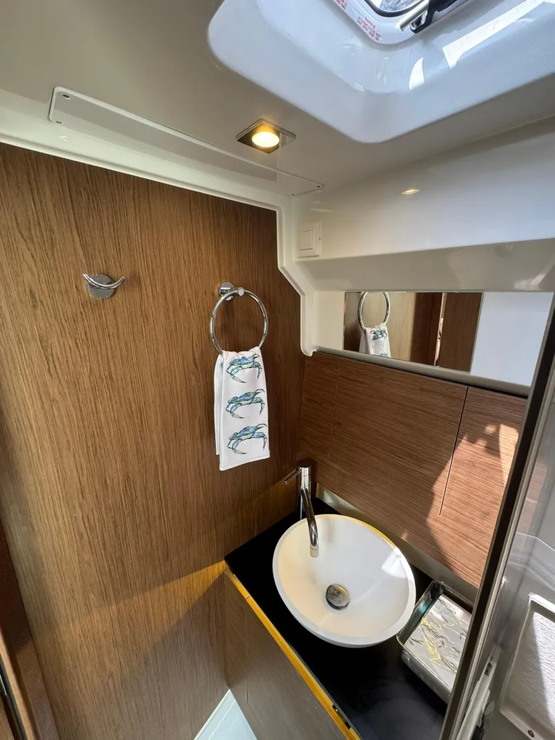 Slide: The Image of 2018 Jeanneau Leader 10.5 bathroom with modern sink and wooden accents. - 29