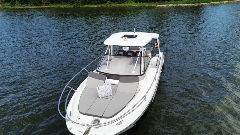 Slide: The Image of 2018 Jeanneau Leader 10.5 boat on calm water, featuring spacious deck and sleek design. - 3