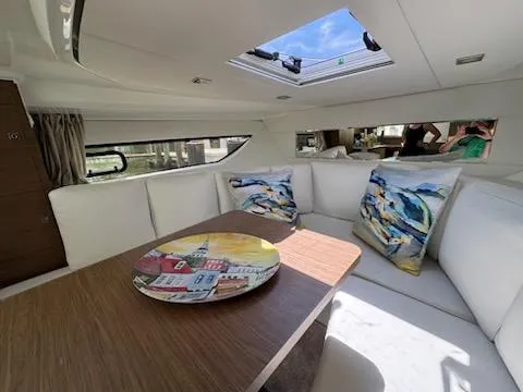 Slide: The Image of Interior of 2018 Jeanneau Leader 10.5 yacht with elegant seating and decorative pillows. - 32