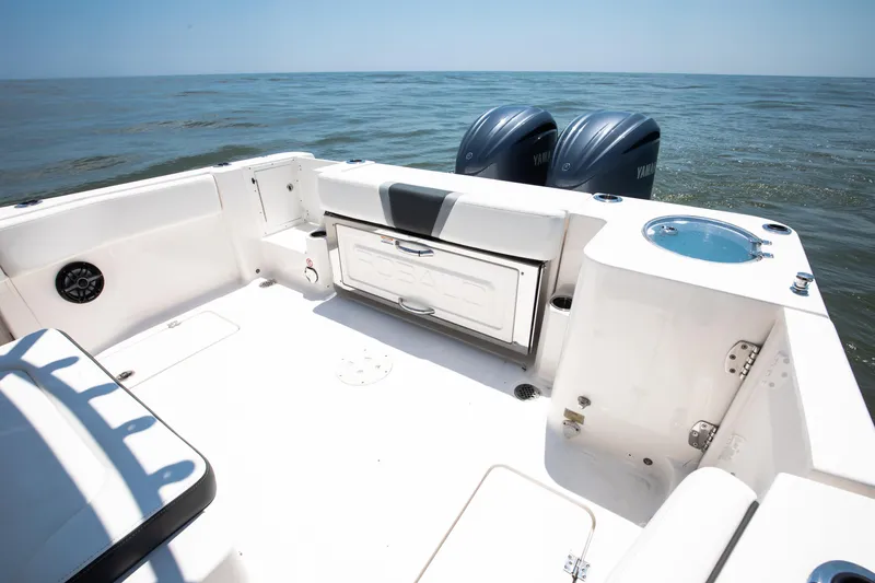 Slide: The Image of 2023 Robalo R270 Center Console boat with dual Yamaha engines on open water. - 11