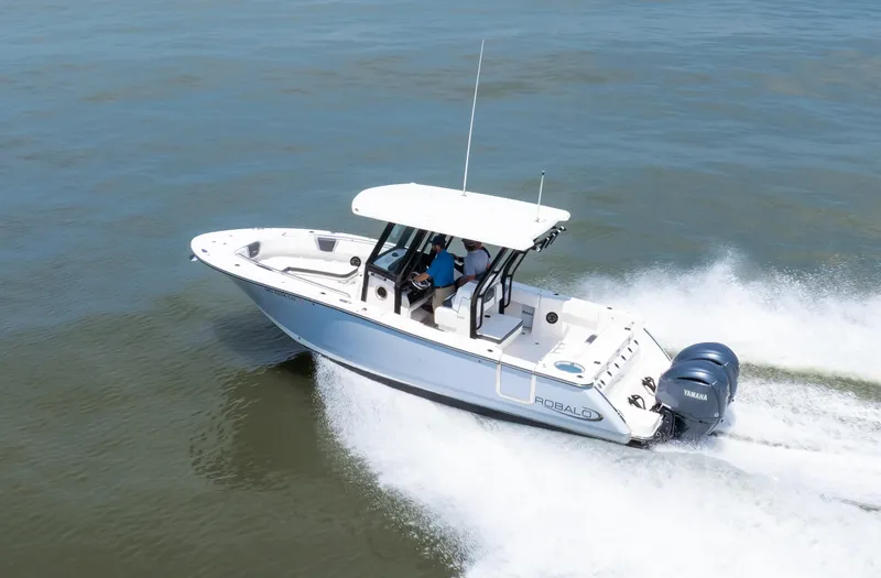 Slide: The Image of 2023 Robalo R270 Center Console boat cruising on open water. - 12